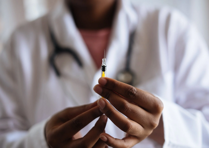 doctor holding syringe